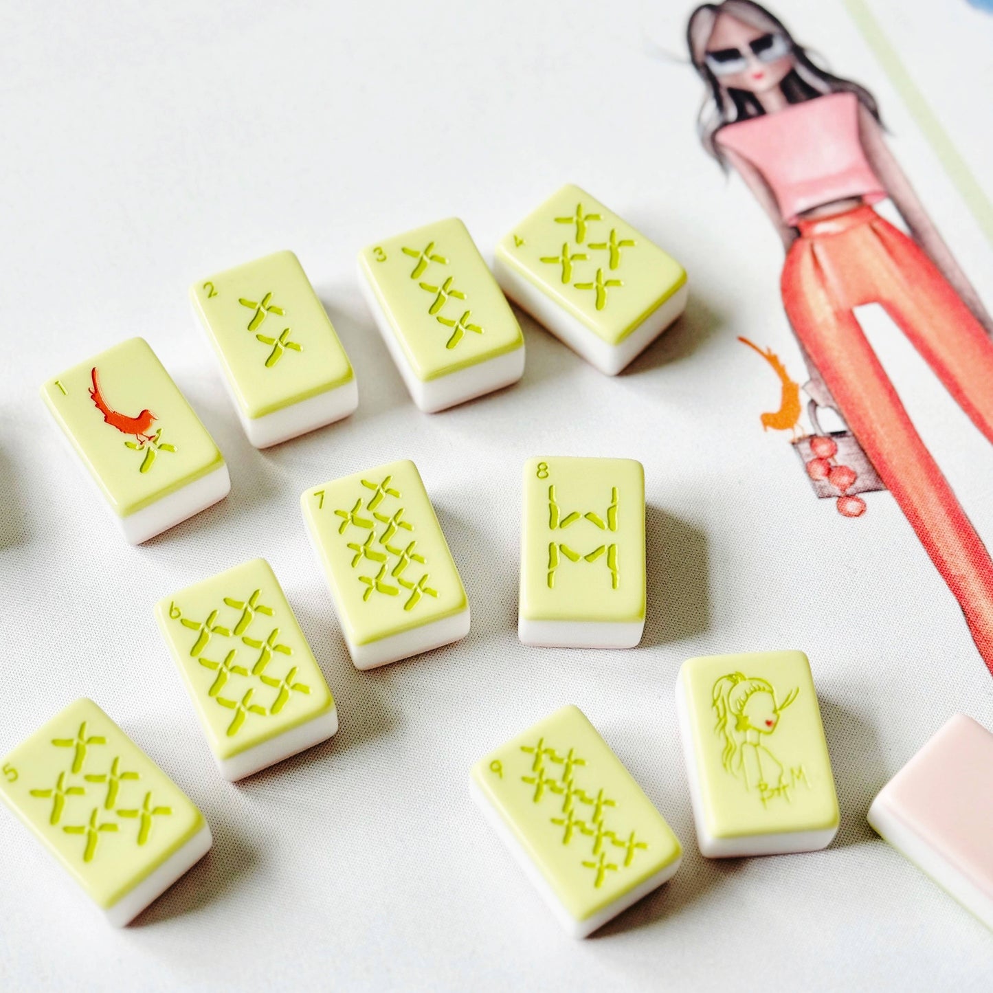 Set of yellow and white rubber stamps on a white surface with a magazine in the background.