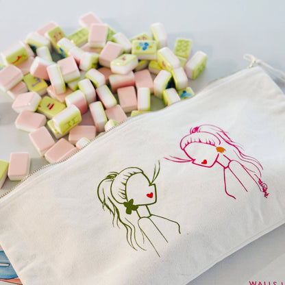 Canvas pouch with illustrations of girls and colorful candies on a light gray background