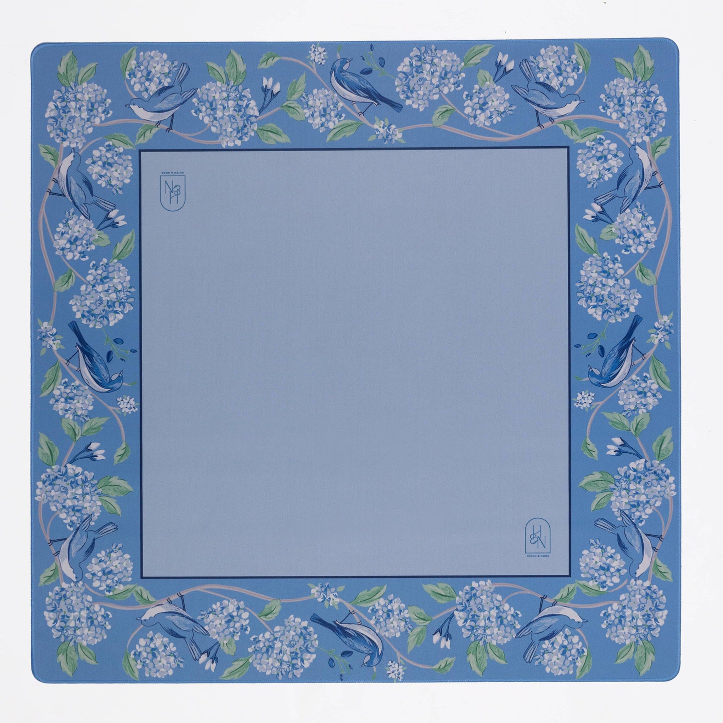 Blue mahjong mat with floral and bird design on a white background