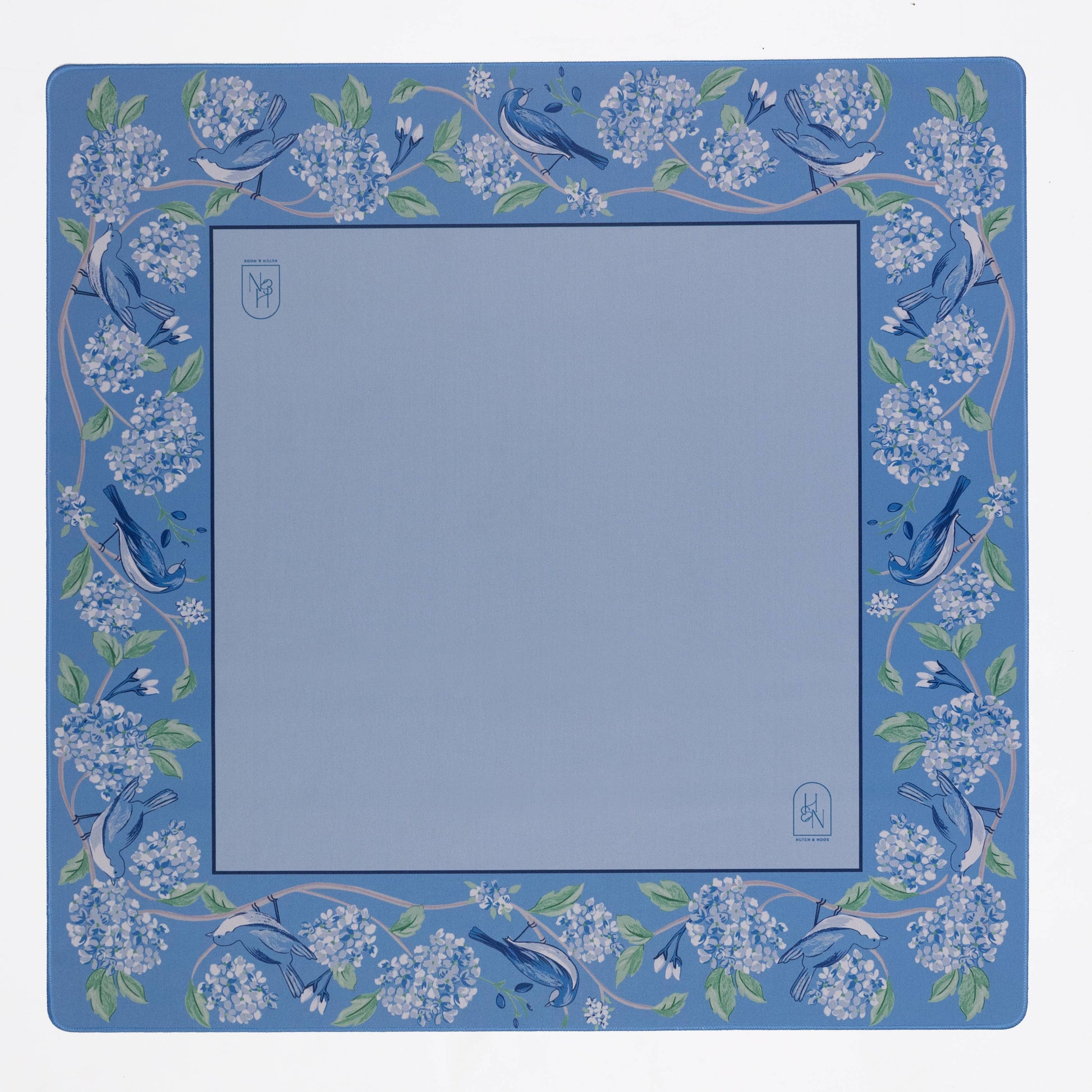 Blue mahjong mat with floral and bird design on a white background