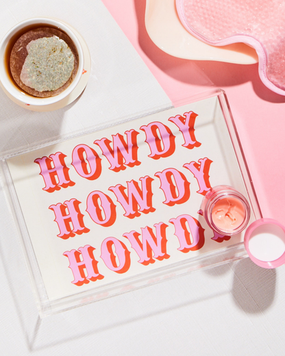 Acrylic jewelry tray with 'HOWDY' text on a pink background