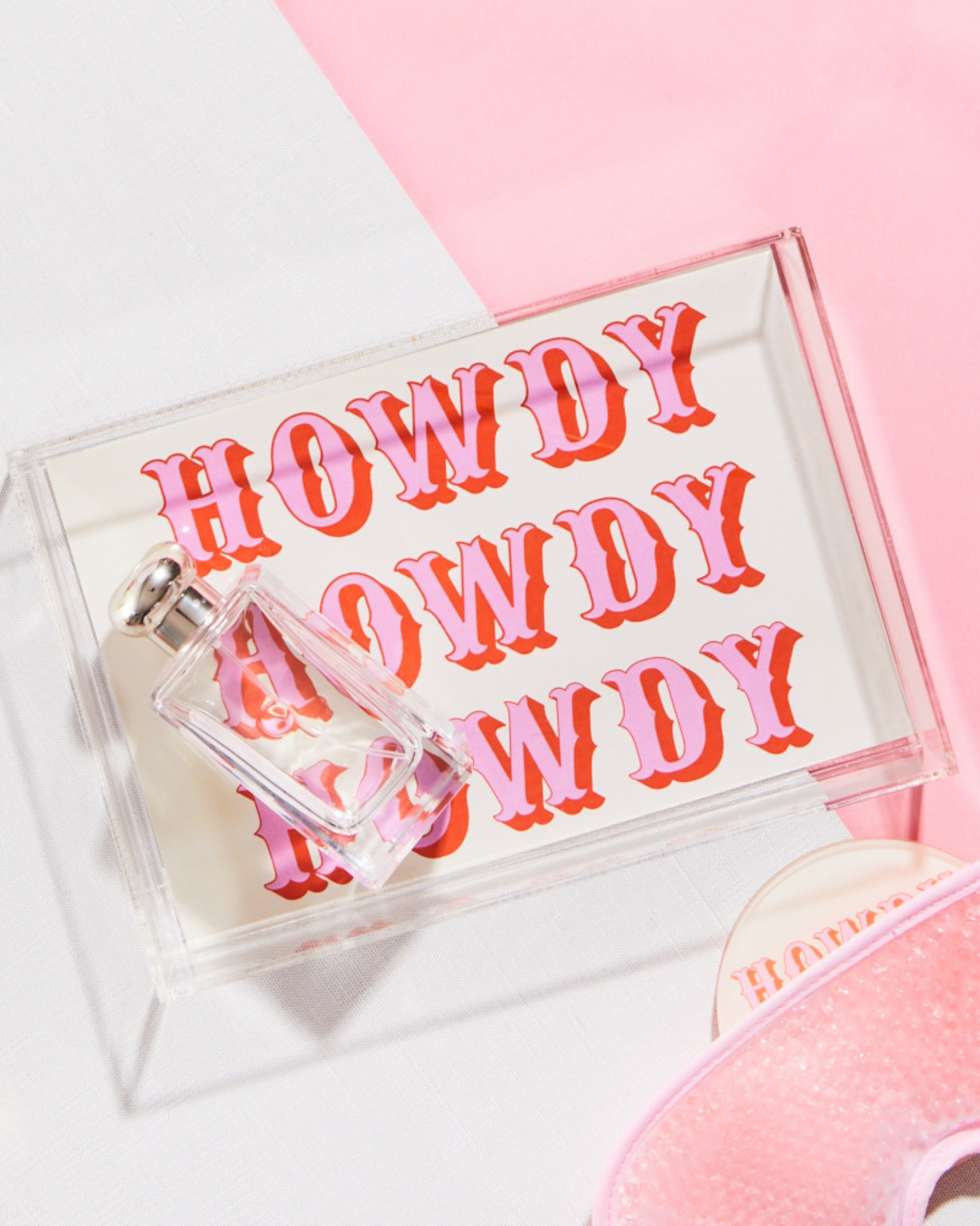 Clear acrylic tray with 'HOWDY' text on a pink background