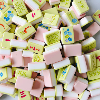 Colorful mahjong tiles with various designs on a white background